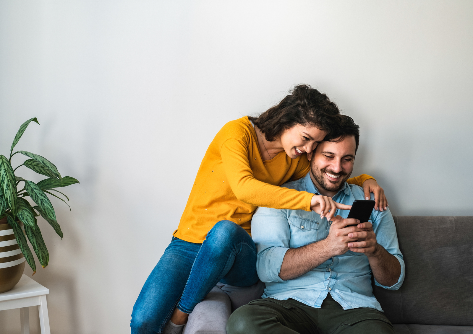 San Diego couple with a baby talking about life insurance at home